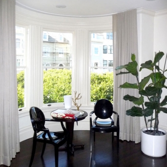 Custom shear curtains in a San Francisco curved window lend privacy but allow the light in
